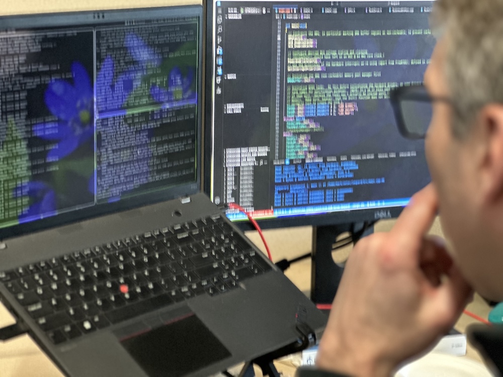 developer working on embedder firmware on laptop
